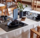 Black square placemats on a restaurant table