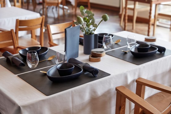 Black square placemats on a restaurant table