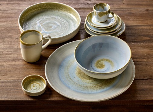Mugs, Cups, Bowls and Plates for restaurants and cafés placed on a rustic wooden table