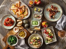 Assorted tapas and seafood served on oriental-inspired professional chinaware, ideal for restaurants and cafés.
