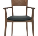 Restaurant Armchair in a dark brown wooden frame and with black artificial leather on seat.