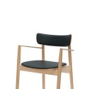 Armchair for café. Light colored wooden frame with black artificial 
