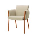 A beige terrace chair with orange metal legs, designed for outdoor use in restaurants or hotels.