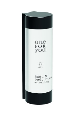 Refillable One for You hand & body lotion dispenser for hotels, mounted in a sleek black wall holder. 320ml white bottle designed for modern hospitality.